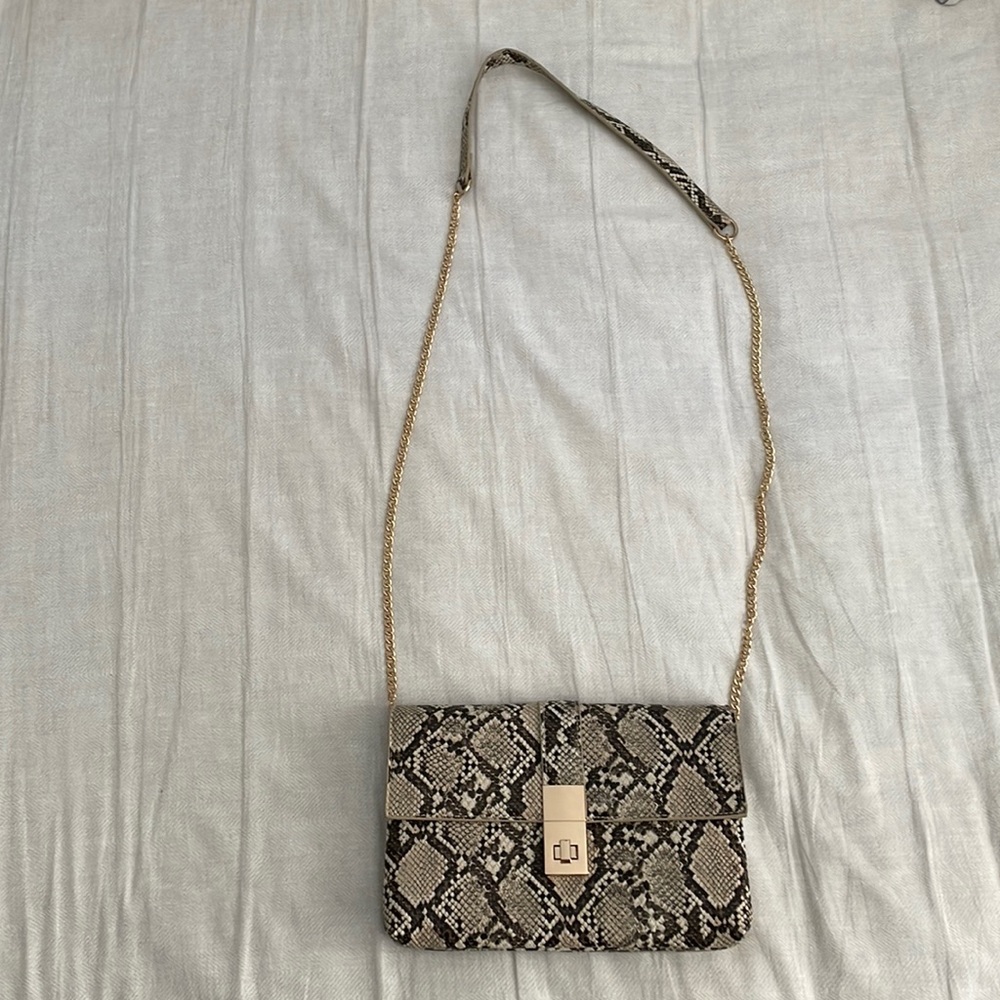 Tan/brown Faux Snakeskin Cross body small purse. Hip length. Used once.